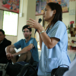 one-of-thailands-top-epidemiologists-speaking-to-a-community-about-dengue-and-malaria-prevention