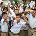 young-boys-holding-up-materials-to-kill-the-mosquito-larvae